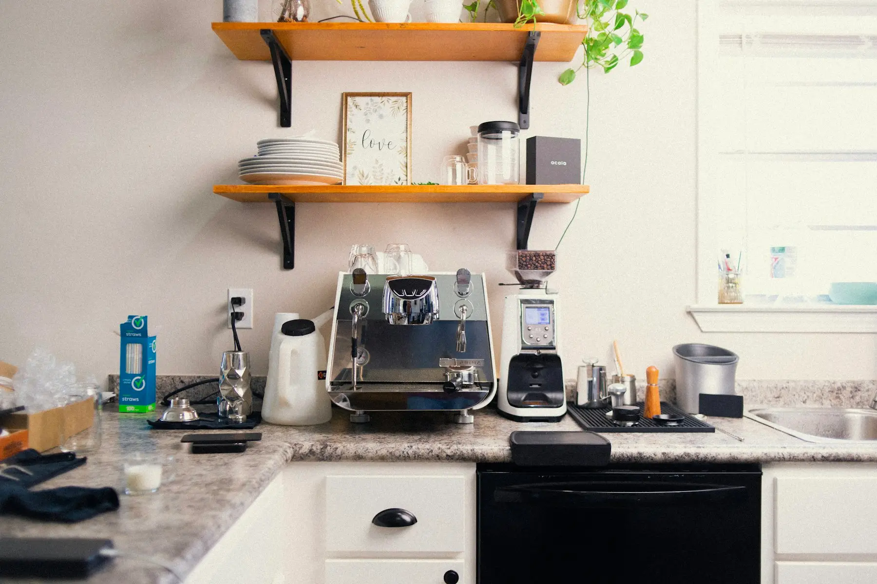 Kitchen counter with a coffee machine under open shelves